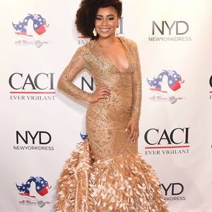 Handmade dress from a Ghana designer. Long feathery train